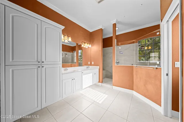 a spacious bathroom with a granite countertop sink and a mirror