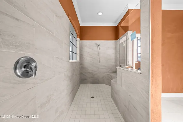 a view of a hall with wooden floor and a potted plant