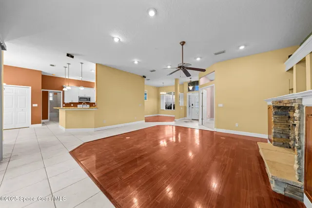 a bedroom with window and wooden floor