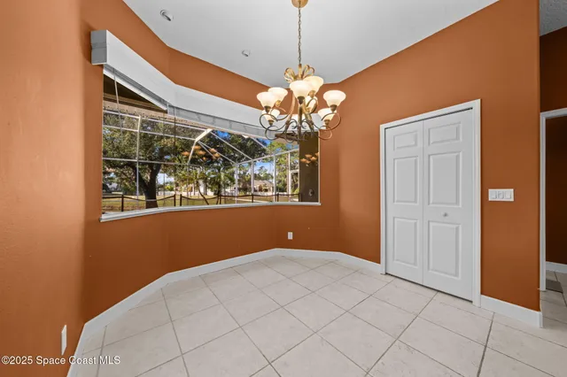 a large white kitchen with kitchen island a sink a counter and cabinets