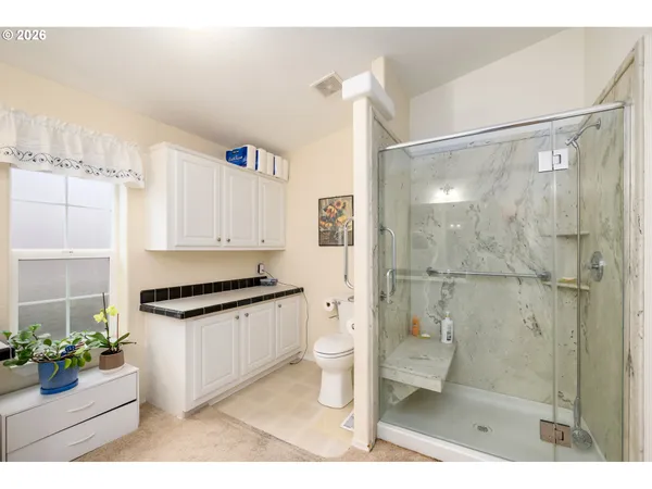 a bathroom with a sink a toilet and shower