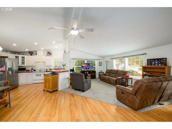 a living room with furniture and kitchen view