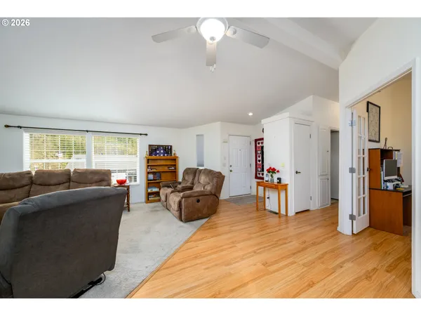 a living room with furniture and a wooden floor
