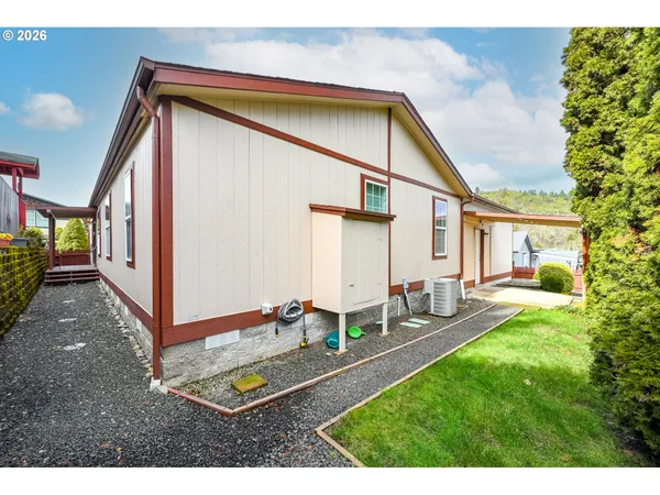 a backyard of a house with table and chairs