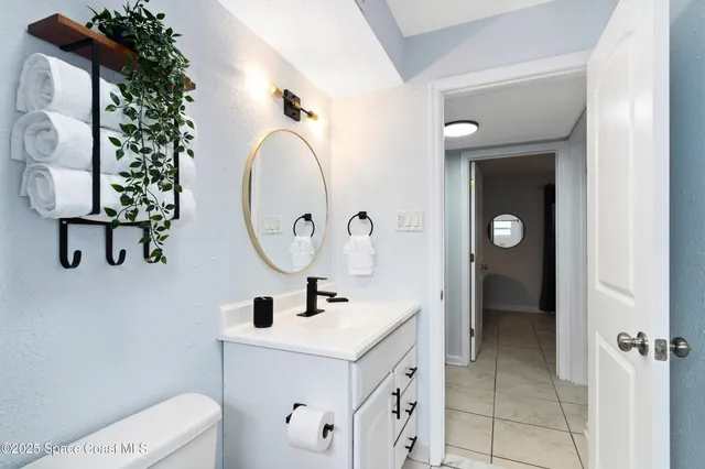 a bathroom with a sink mirror and vanity
