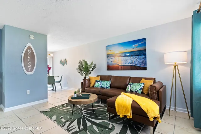 a living room with furniture and a lamp