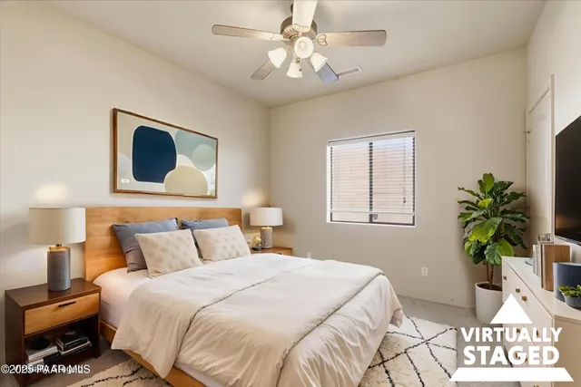 a bedroom with a bed and a potted plant