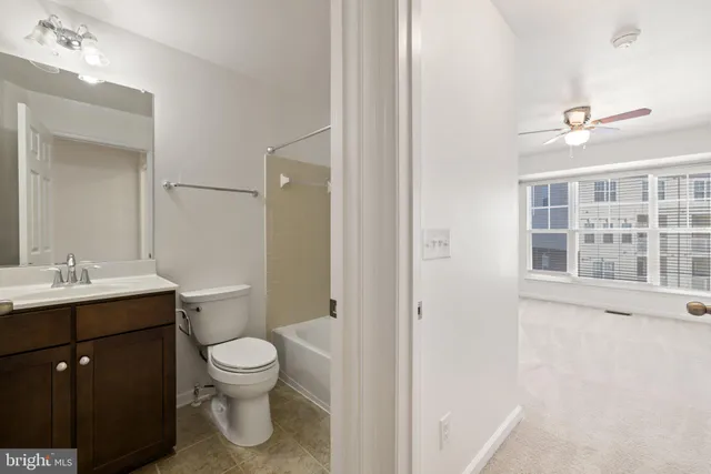 a bathroom with a sink toilet vanity and shower