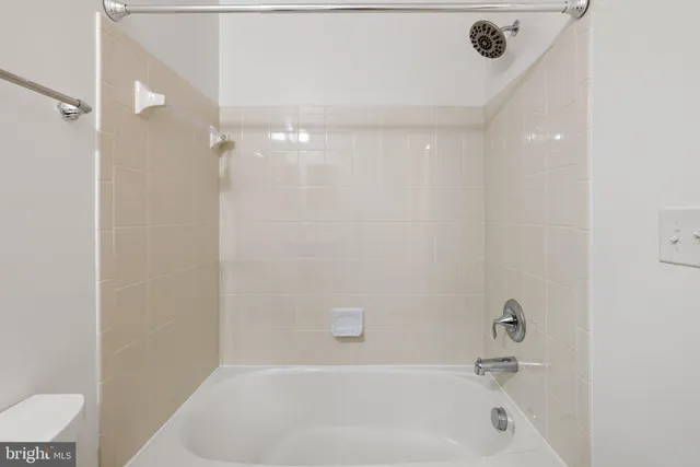 an empty room with window and a ceiling fan