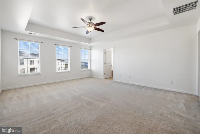 a view of an empty room with a ceiling fan