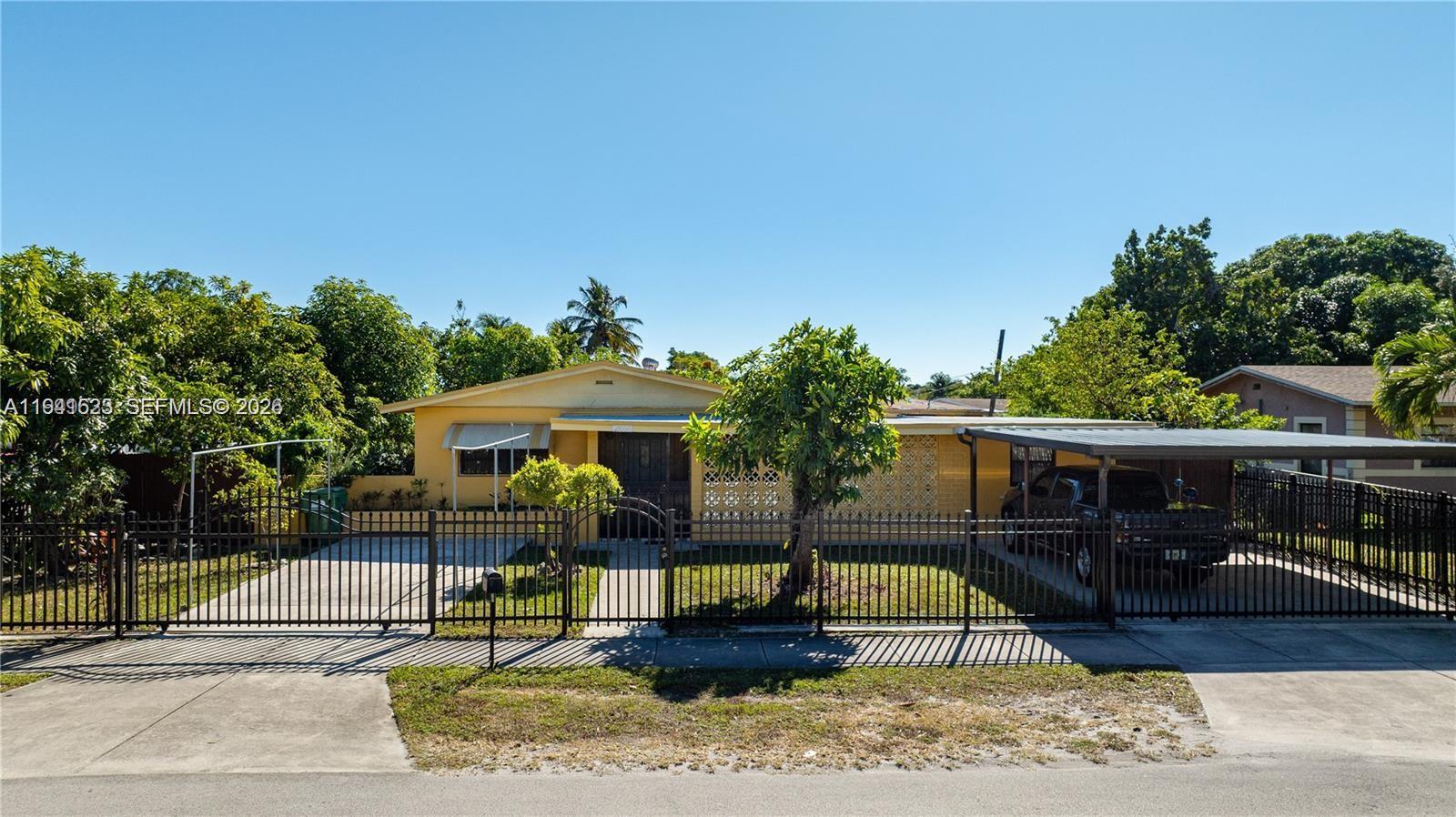 2000 Northwest 131st Street Miami, FL 33167 - Photo 3 of 18 a front view of a house with garden