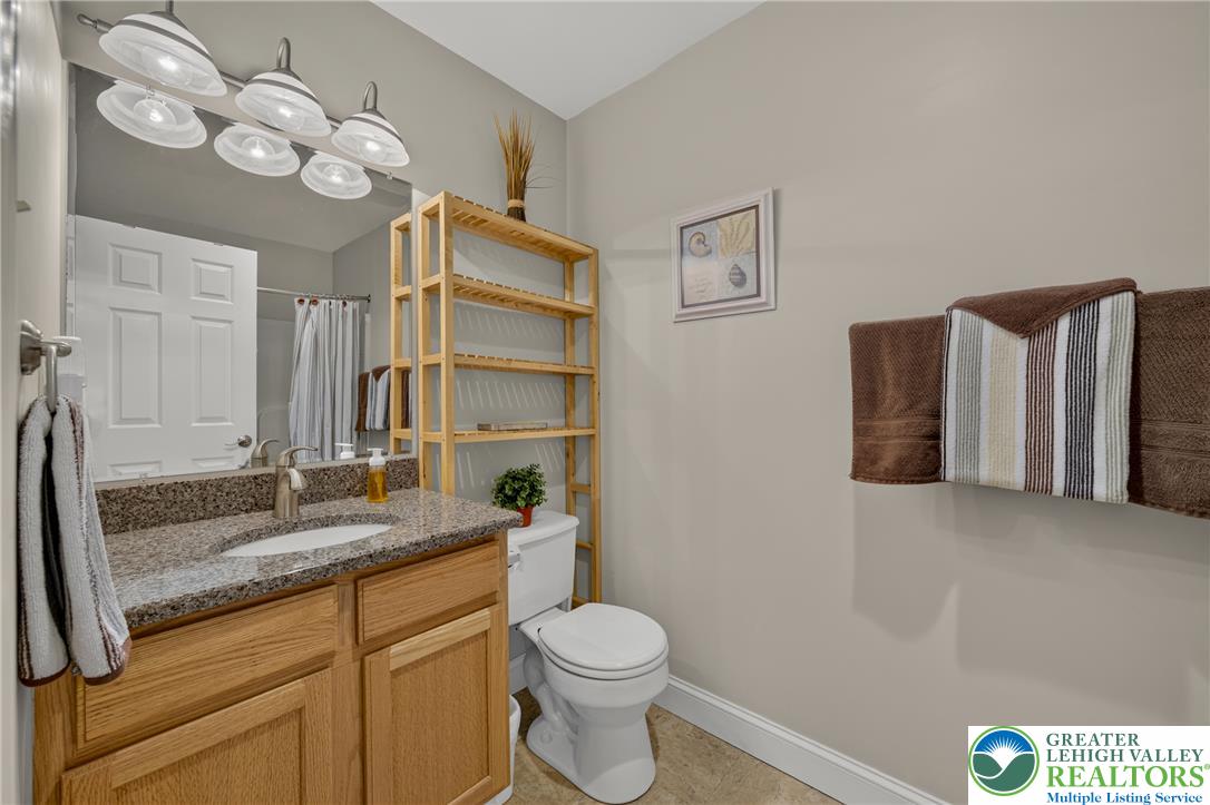 1702 Red Bud Road Quakertown, PA 18951 - Photo 47 of 68 Functional full bathroom with granite counters and a practical wooden storage unit.