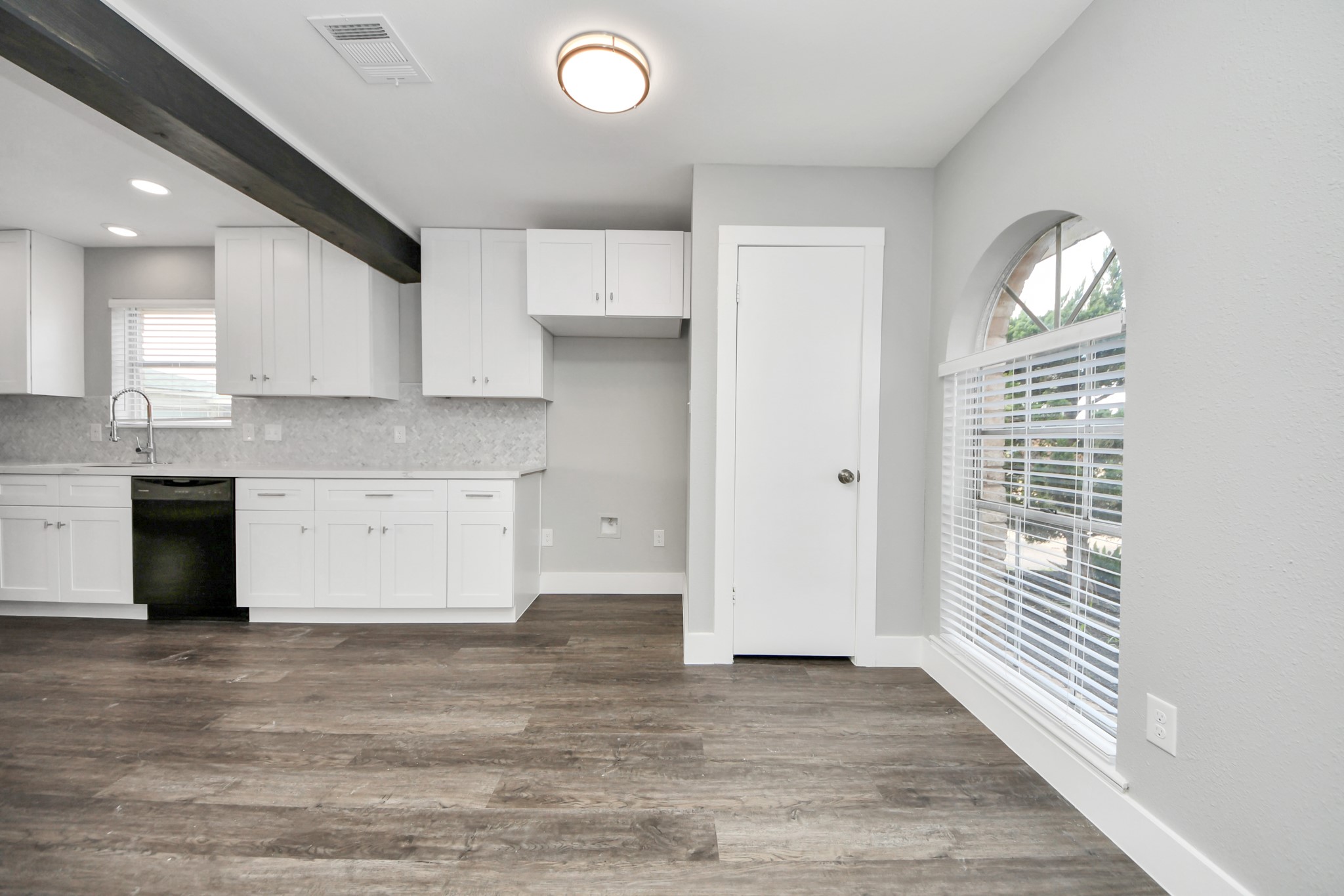 15423 Ridingwood Drive Houston, TX 77489 - Photo 14 of 43 a view of a kitchen with wooden floor and a window