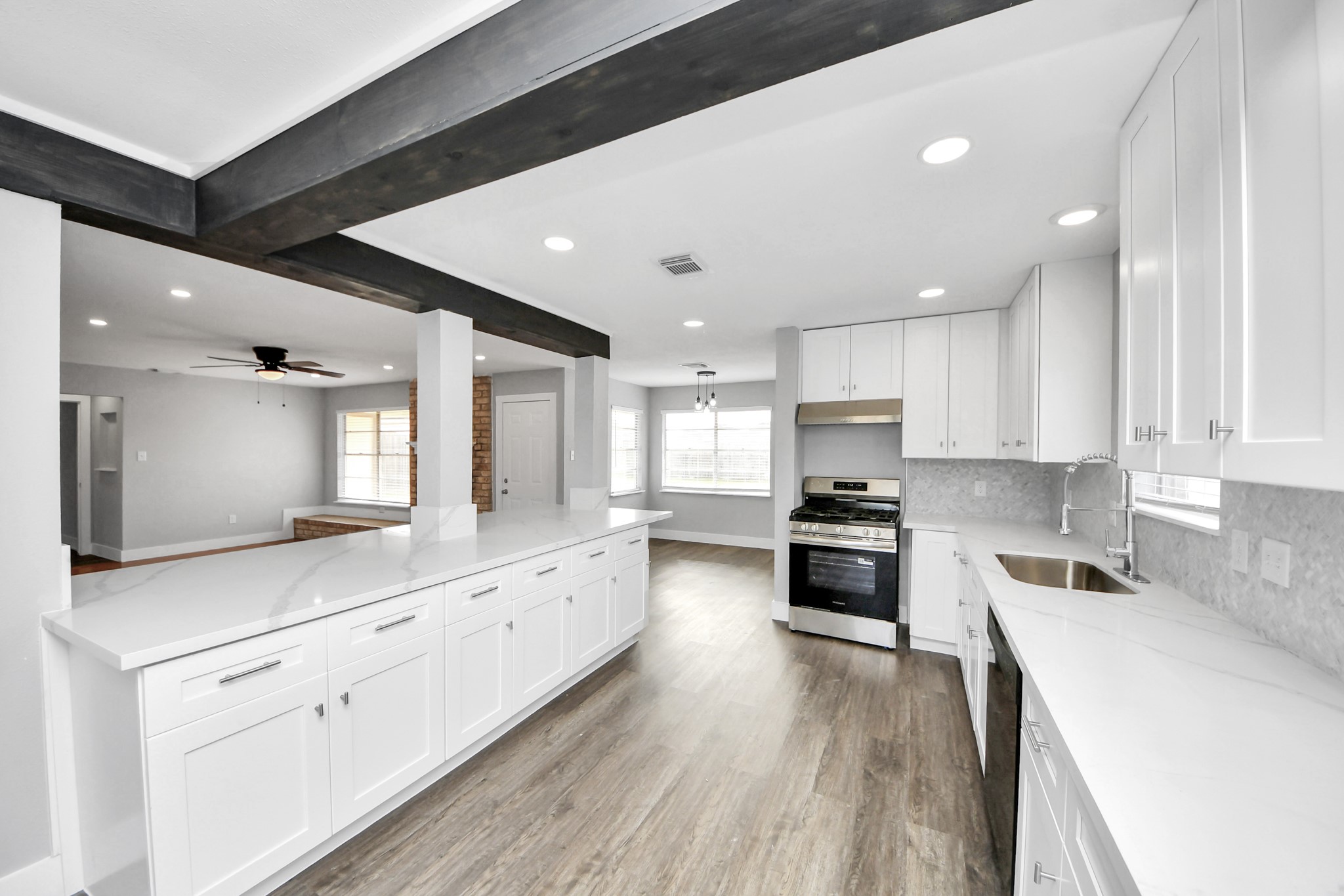 15423 Ridingwood Drive Houston, TX 77489 - Photo 17 of 43 a kitchen with granite countertop a stove top oven sink and cabinets