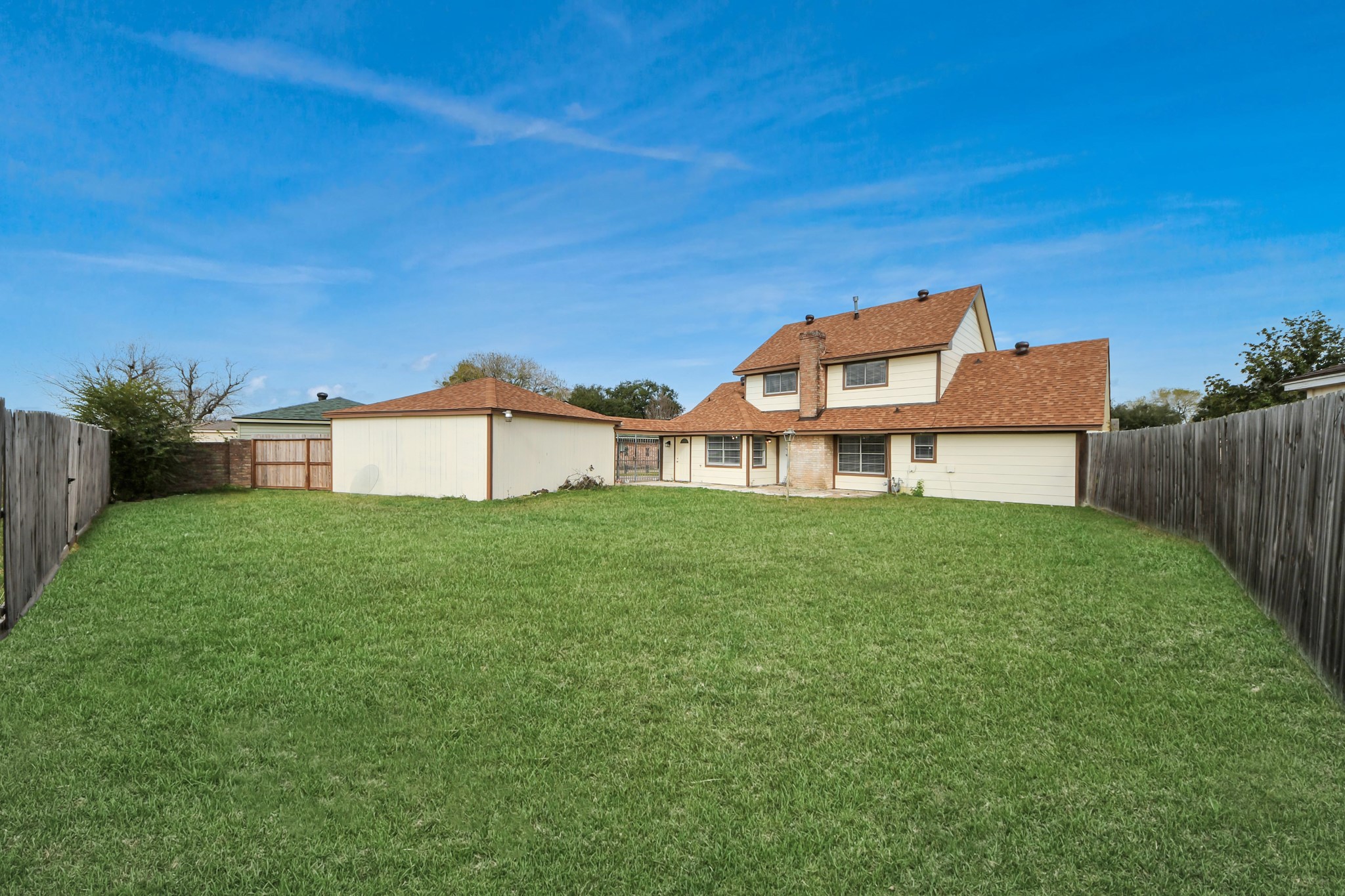 15423 Ridingwood Drive Houston, TX 77489 - Photo 39 of 43 a view of a house with a big yard potted plants and wooden fence