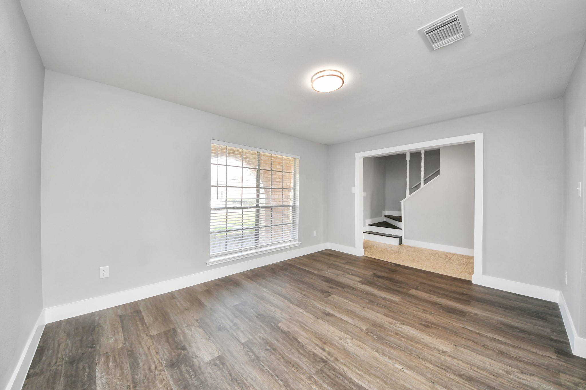 15423 Ridingwood Drive Houston, TX 77489 - Photo 6 of 43 a view of an empty room with wooden floor and a window