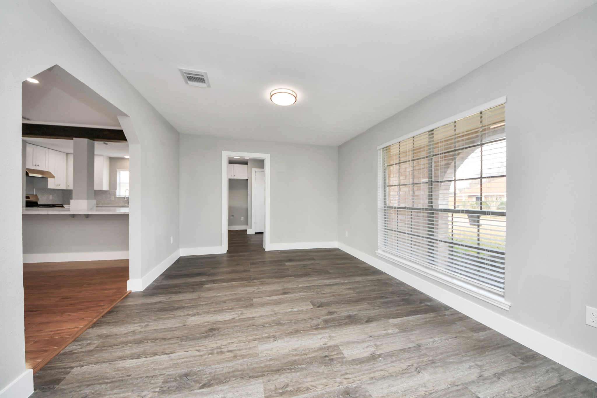 15423 Ridingwood Drive Houston, TX 77489 - Photo 7 of 43 a view of an empty room with wooden floor and a window