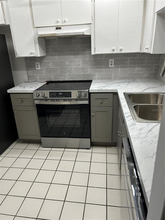 4422 Sunstate Drive New Port Richey, FL 34652 - Photo 6 of 19 a kitchen with a stove top oven and cabinets