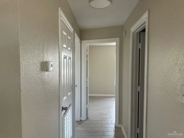 a view of a hallway with wooden floor