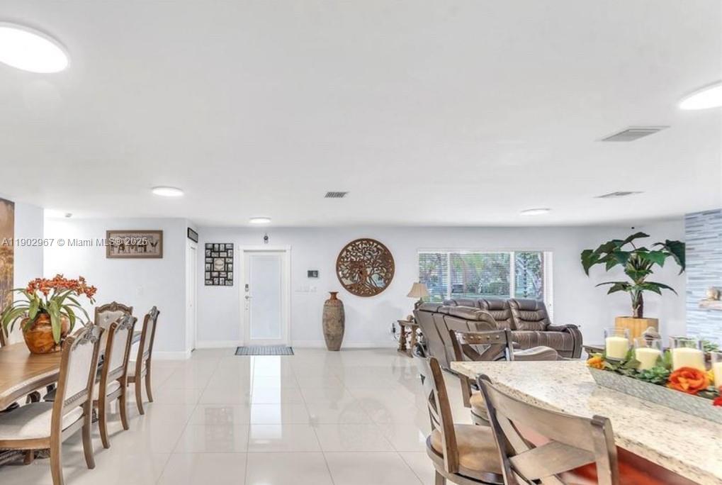 16891 Southwest 277th Street Homestead, FL 33031 - Photo 12 of 47 a view of a dining room with furniture and a large window