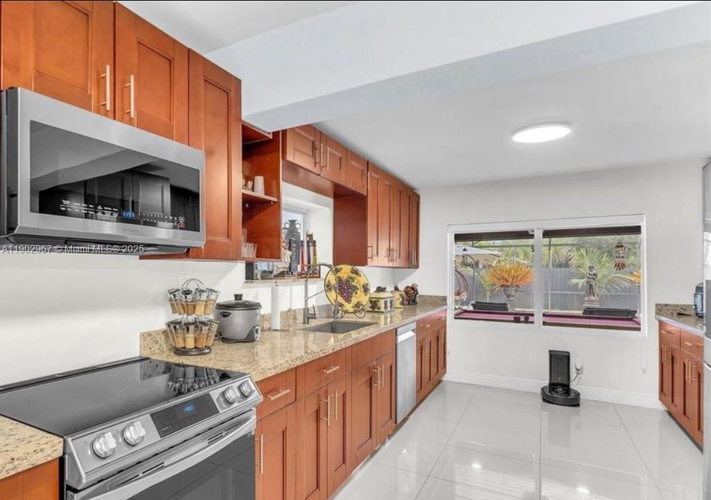 16891 Southwest 277th Street Homestead, FL 33031 - Photo 14 of 47 a kitchen with a sink stove and microwave