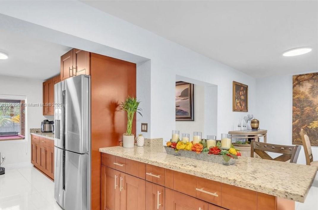 16891 Southwest 277th Street Homestead, FL 33031 - Photo 15 of 47 a kitchen with stainless steel appliances granite countertop a refrigerator and a sink
