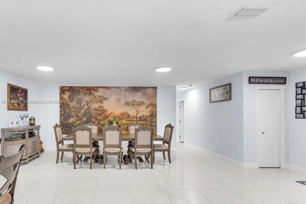 16891 Southwest 277th Street Homestead, FL 33031 - Photo 16 of 47 a view of a dining area with furniture and a large window