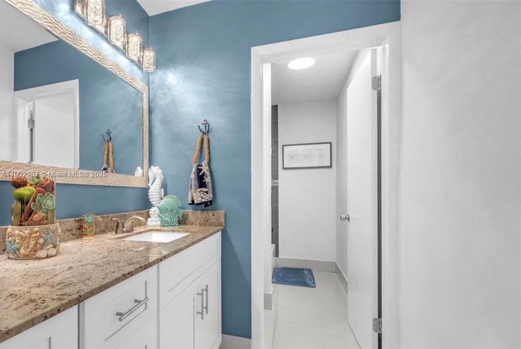 16891 Southwest 277th Street Homestead, FL 33031 - Photo 17 of 47 a bathroom with a granite countertop sink and a mirror