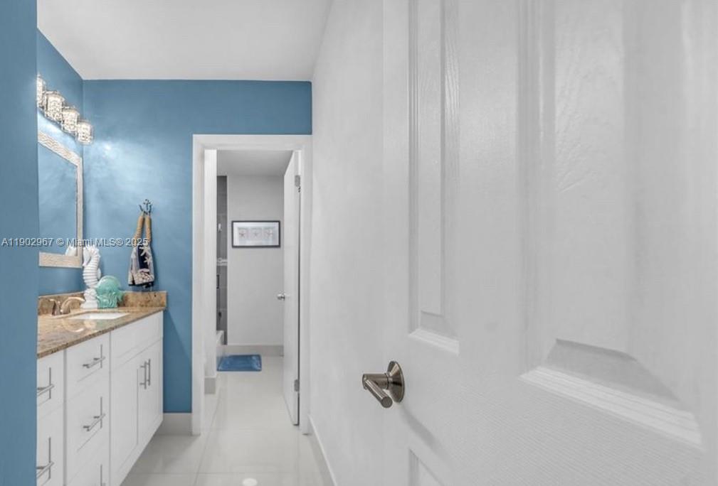 16891 Southwest 277th Street Homestead, FL 33031 - Photo 18 of 47 a bathroom with a sink and a mirror