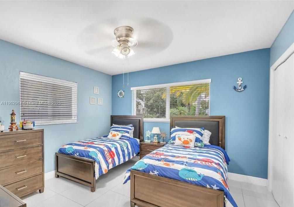 16891 Southwest 277th Street Homestead, FL 33031 - Photo 23 of 47 a bedroom with two beds and a window