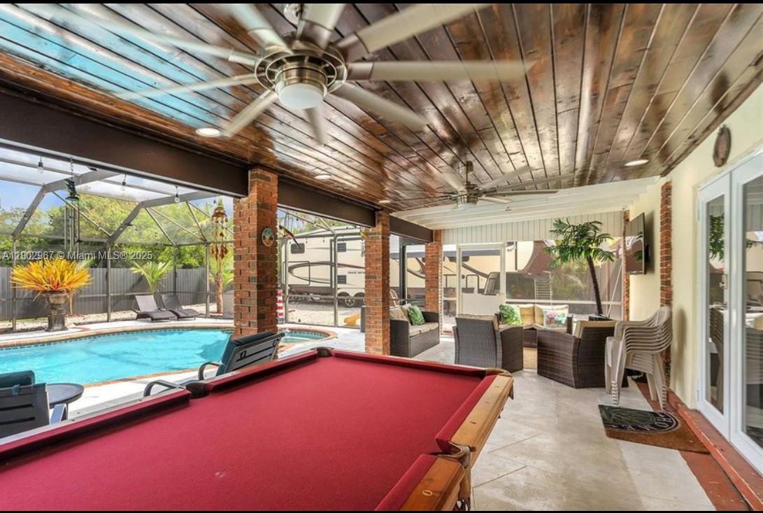 16891 Southwest 277th Street Homestead, FL 33031 - Photo 25 of 47 a room with pool table and windows