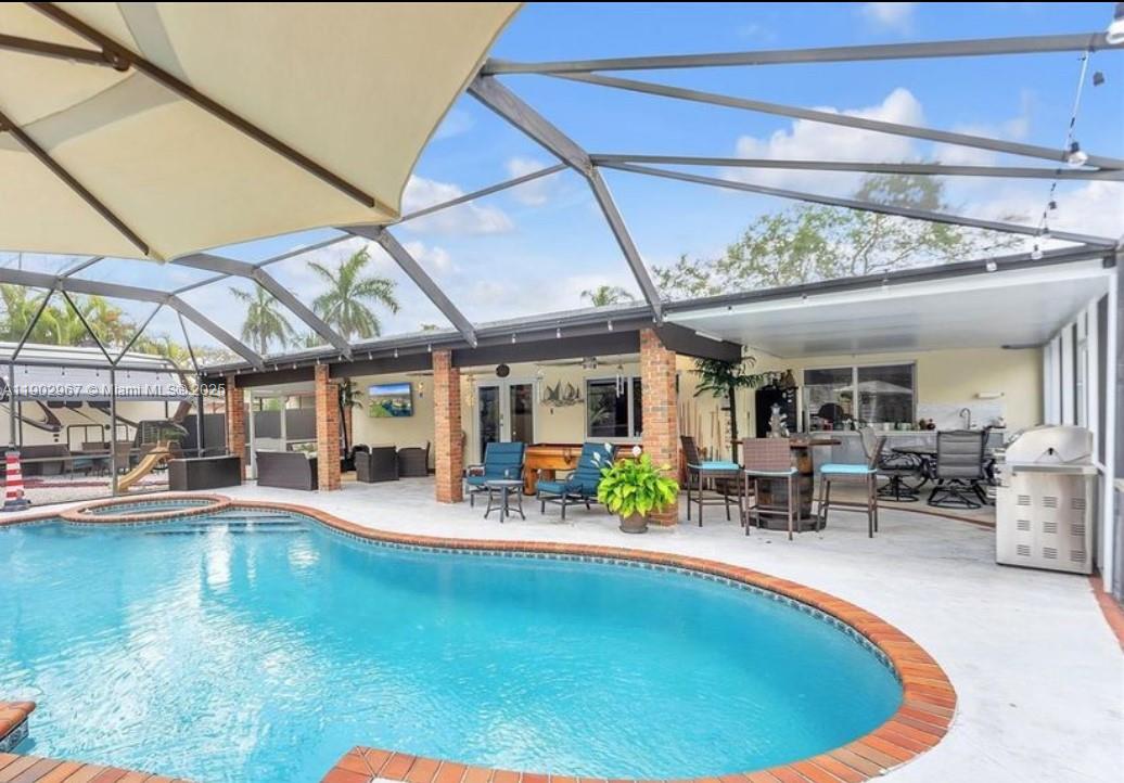 16891 Southwest 277th Street Homestead, FL 33031 - Photo 31 of 47 a view of a swimming pool with outdoor seating
