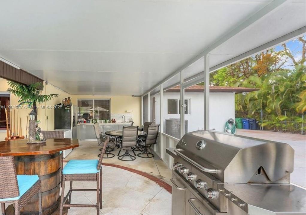 16891 Southwest 277th Street Homestead, FL 33031 - Photo 32 of 47 a living room with furniture and large windows