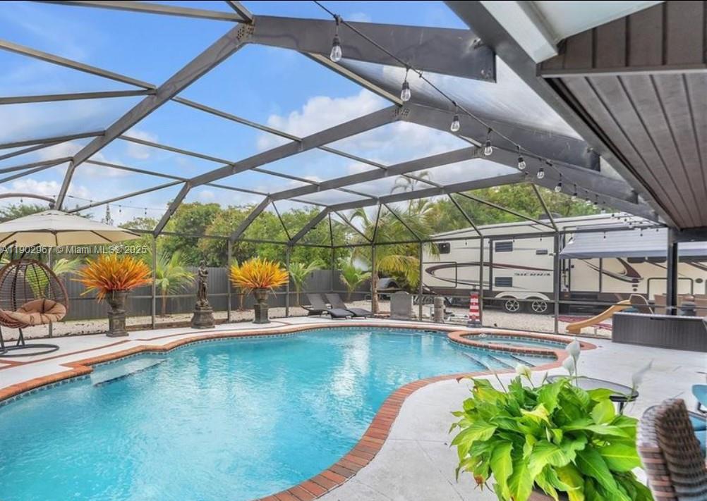 16891 Southwest 277th Street Homestead, FL 33031 - Photo 33 of 47 a view of a swimming pool with a patio