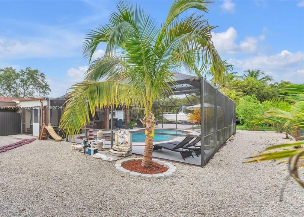 16891 Southwest 277th Street Homestead, FL 33031 - Photo 34 of 47 a view of a backyard with a patio