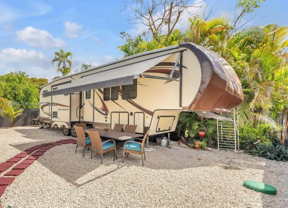 16891 Southwest 277th Street Homestead, FL 33031 - Photo 35 of 47 a backyard of a house with table and chairs