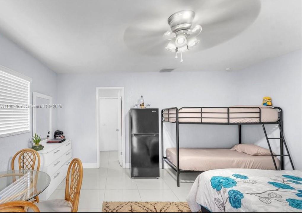16891 Southwest 277th Street Homestead, FL 33031 - Photo 38 of 47 a bedroom with a bed and a chandelier