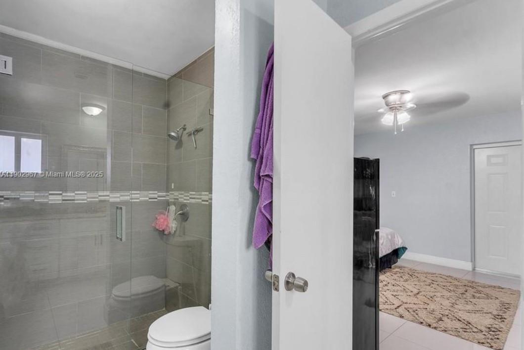 16891 Southwest 277th Street Homestead, FL 33031 - Photo 40 of 47 a bathroom with a granite countertop shower sink vanity and toilet