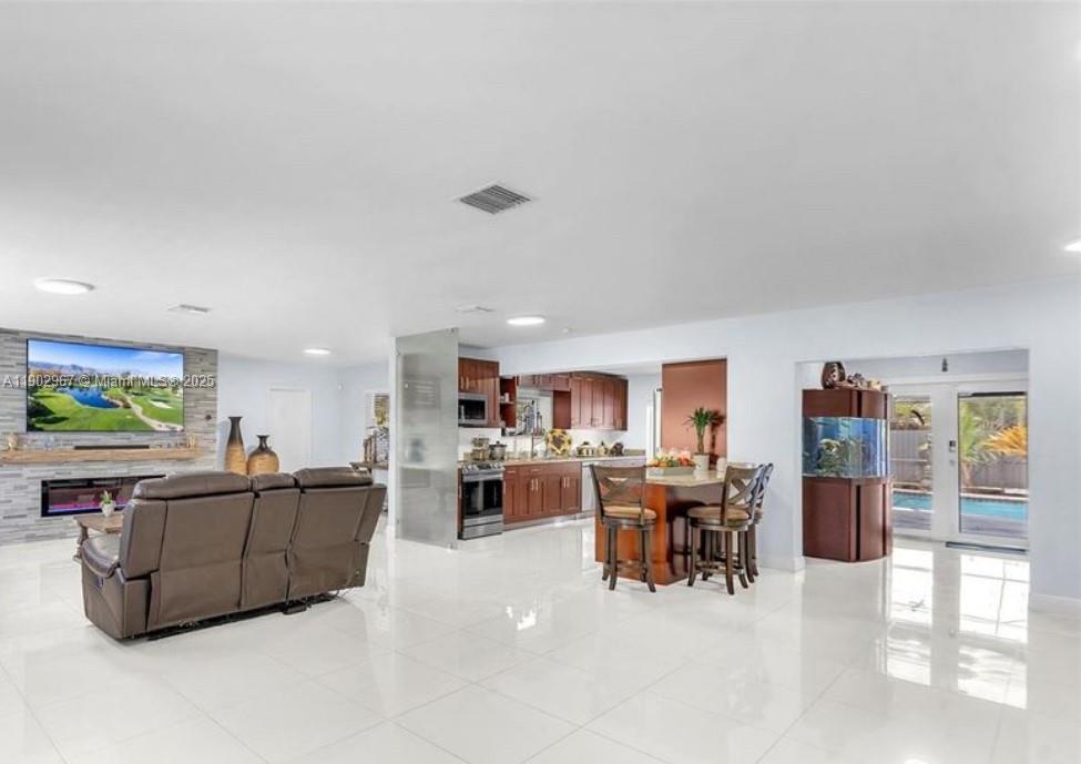 16891 Southwest 277th Street Homestead, FL 33031 - Photo 5 of 47 a living room with furniture and a flat screen tv