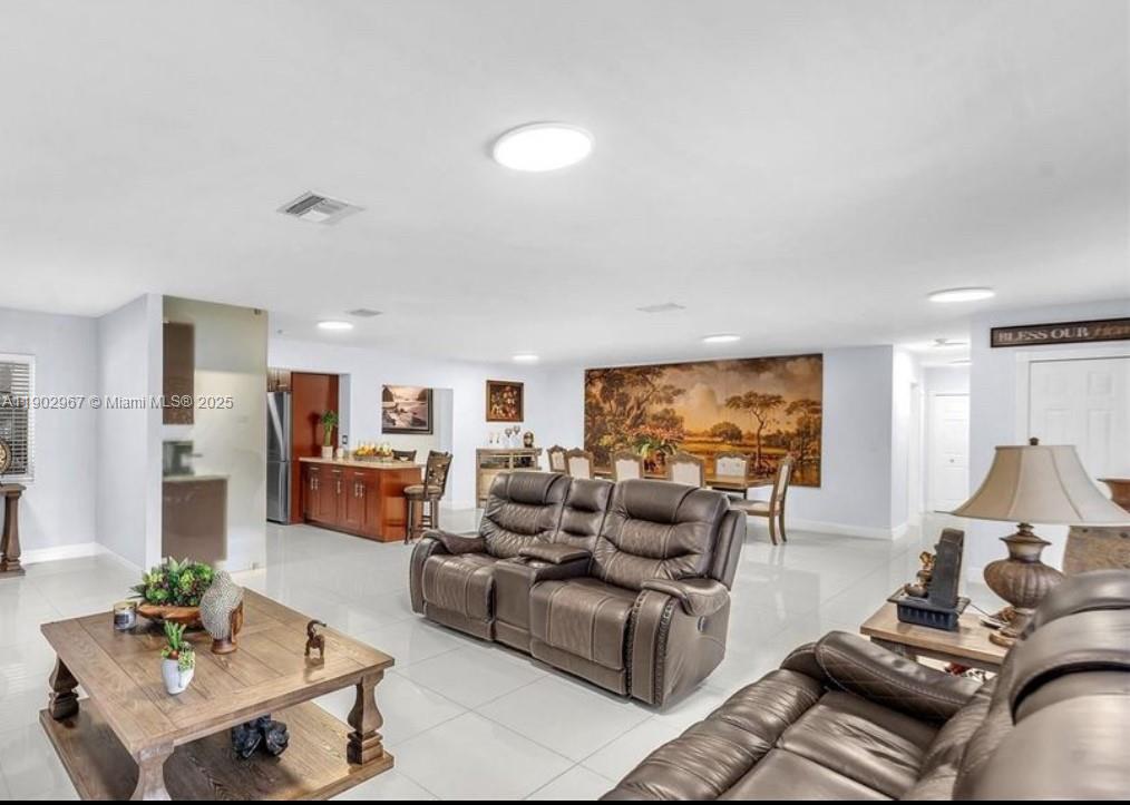 16891 Southwest 277th Street Homestead, FL 33031 - Photo 7 of 47 a living room with furniture and a large window