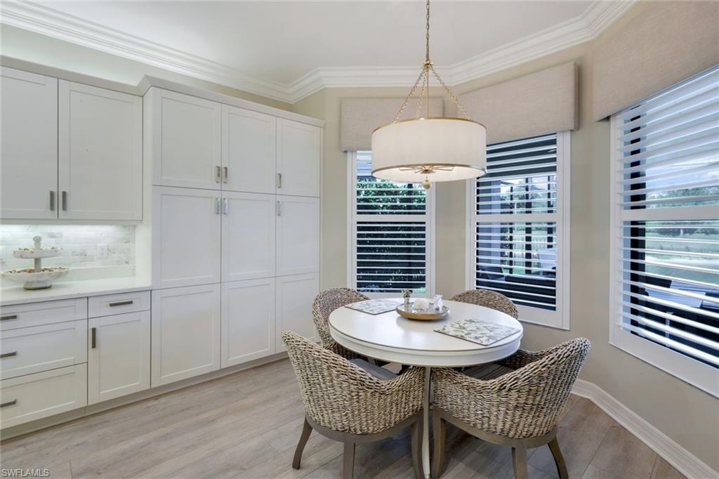 4478 Caldera Circle Naples, FL 34119 - Photo 14 of 50 Large Breakfast dining area with view of pool and lake has room to seat 4 or 8!