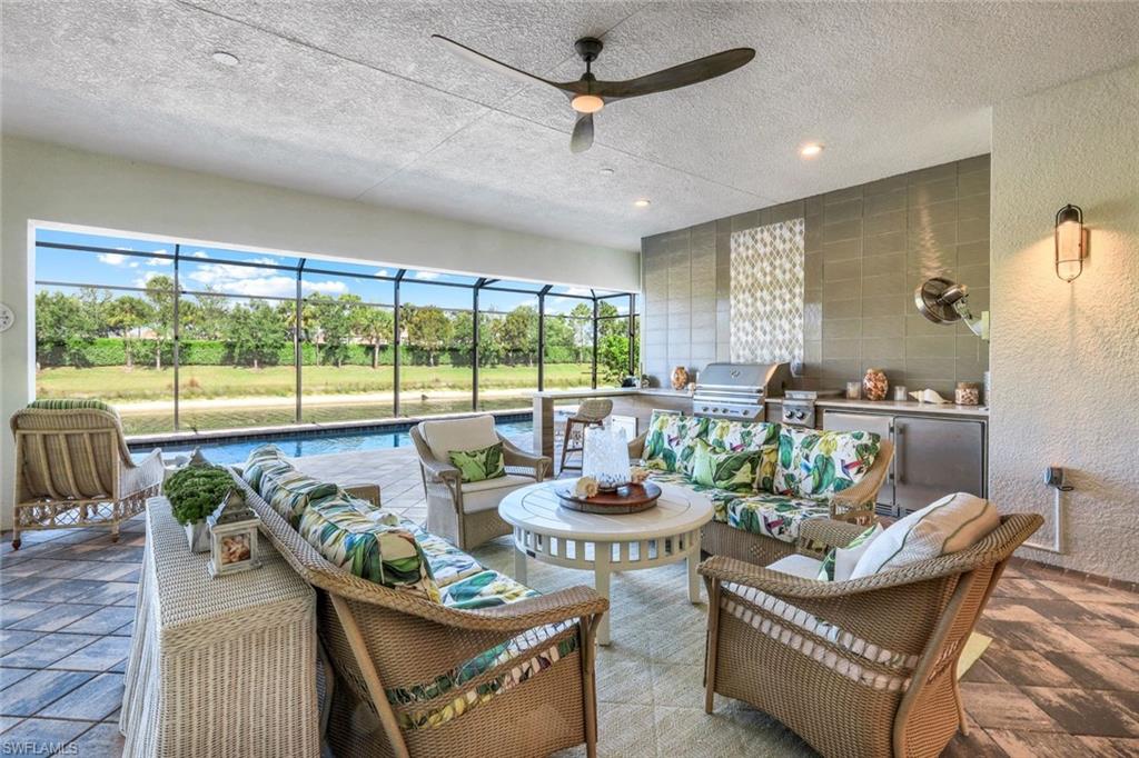 4478 Caldera Circle Naples, FL 34119 - Photo 30 of 50 Spectacular Outdoor Living features the Huge Extended Lanai that offers an outside home of poolside seating, dining, sunbathing and cooking!!