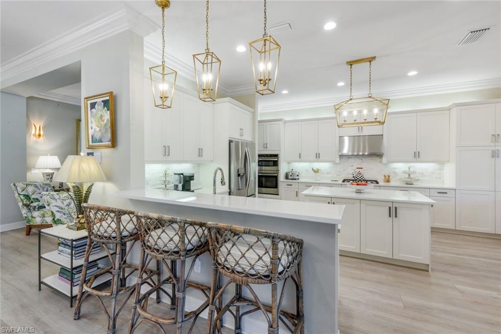 4478 Caldera Circle Naples, FL 34119 - Photo 7 of 50 Large kitchen with new appliances and lighting, gas cooktop offers space for family "chefery"