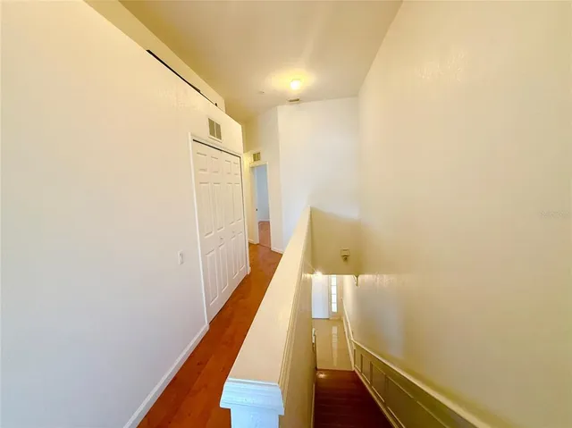 a view of hallway with wooden floor