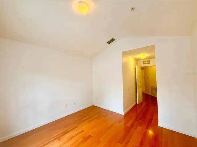 a view of a room with wooden floor and bench