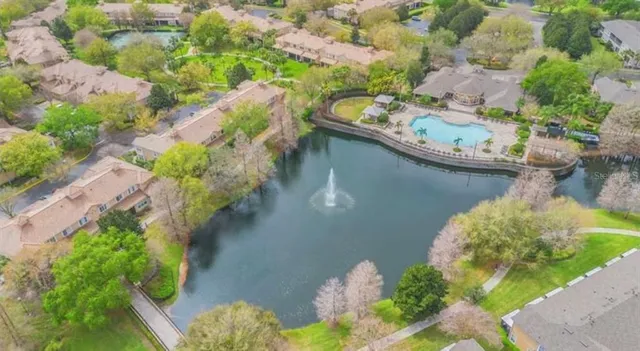 an aerial view of a house with a yard and lake view