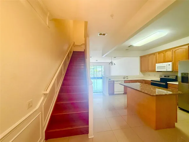 a kitchen with stainless steel appliances granite countertop a sink and cabinets