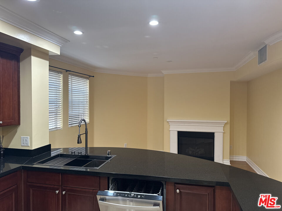 122 North Clark Drive, Unit 105 West Hollywood, CA 90048 - Photo 11 of 28 a kitchen with a sink and a stove