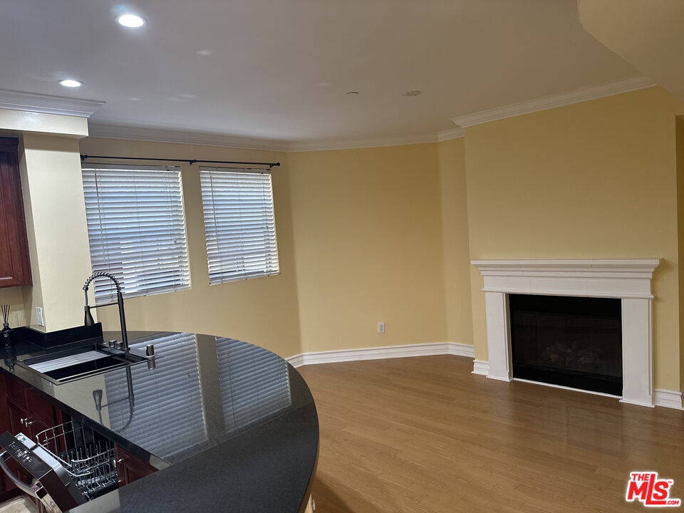 122 North Clark Drive, Unit 105 West Hollywood, CA 90048 - Photo 12 of 28 a living room with furniture and a fireplace