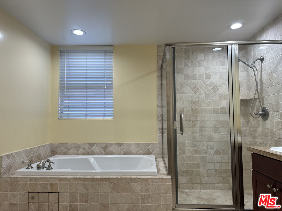 122 North Clark Drive, Unit 105 West Hollywood, CA 90048 - Photo 21 of 28 a bathroom with a bathtub and a shower